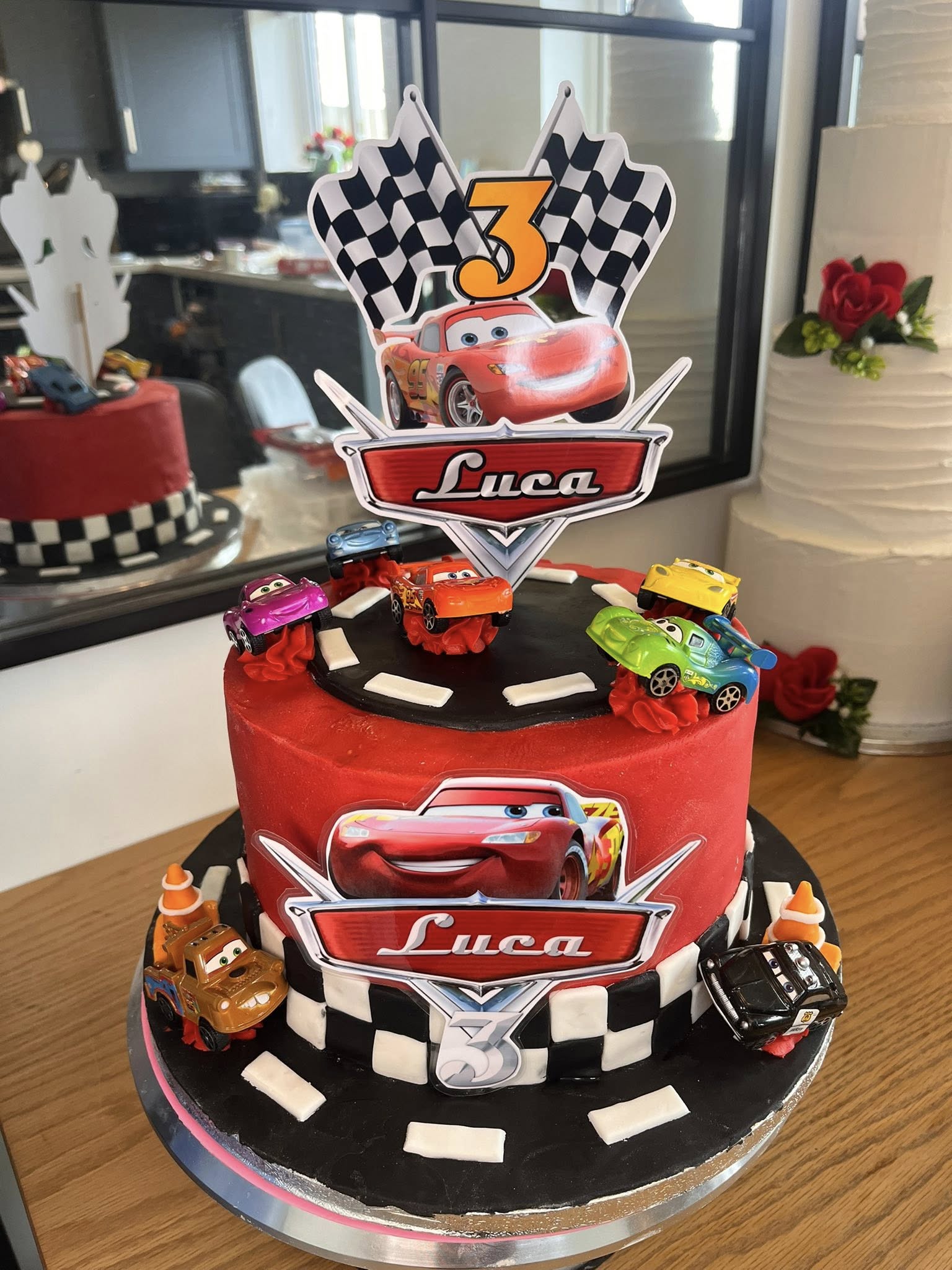 Brightly colored cake with car decorations