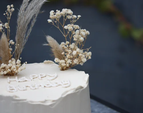Buttercream celebration cake finished with dried flowers, handmade by Polar Bakes in Ebbw Vale