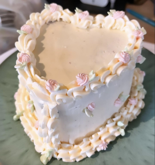 Heart-shaped birthday cake with pink flowers