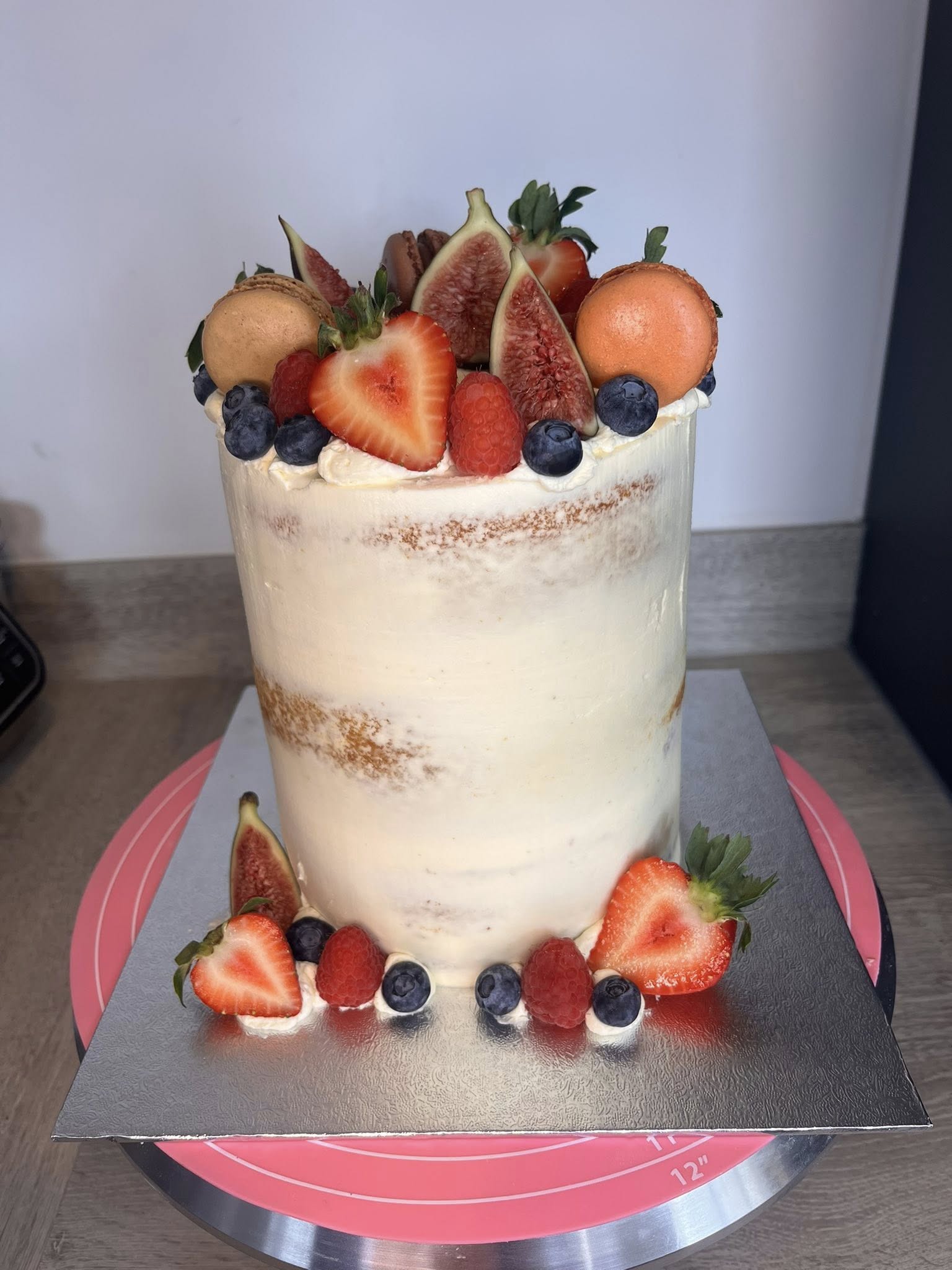 Tall birthday cake with fresh fruit topping