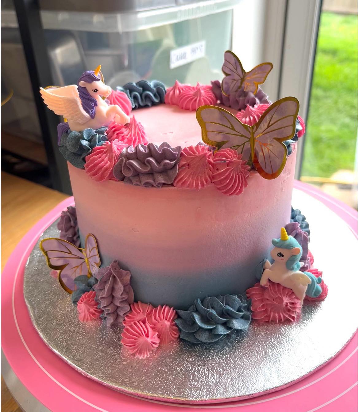 Unicorn themed birthday cake with butterflies