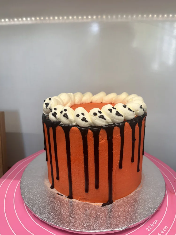 Halloween cake with ghosts and drip decoration