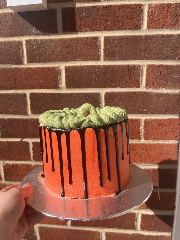 Orange Halloween cake with black chocolate drip