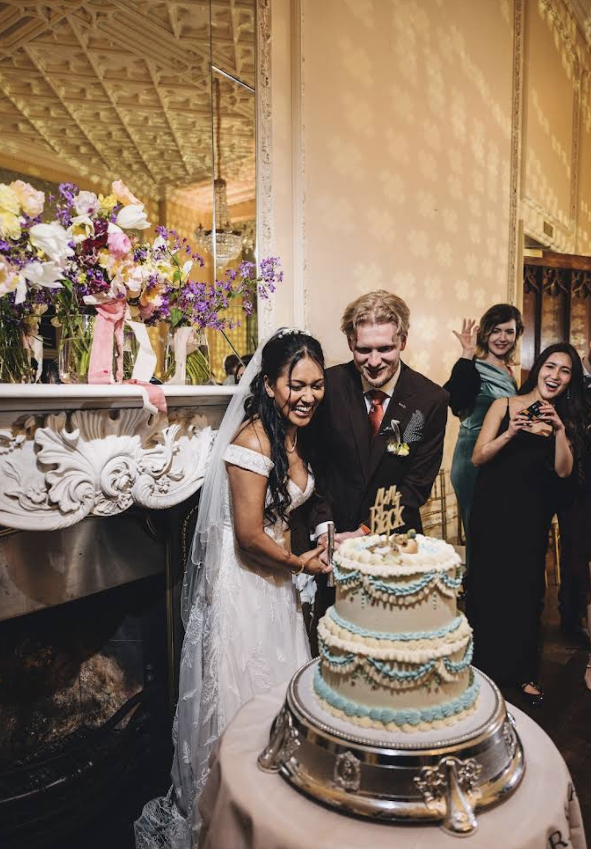Wedding cake with blue and white decorations and cherries